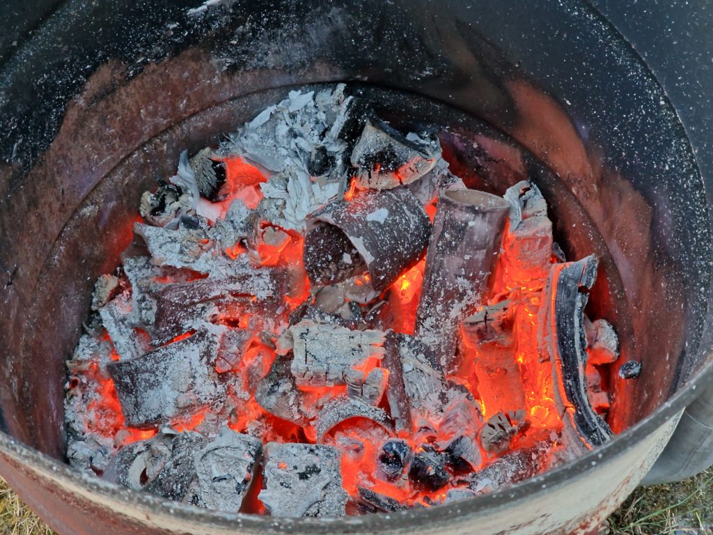 Opening the oil barrel pit fire pottery kiln