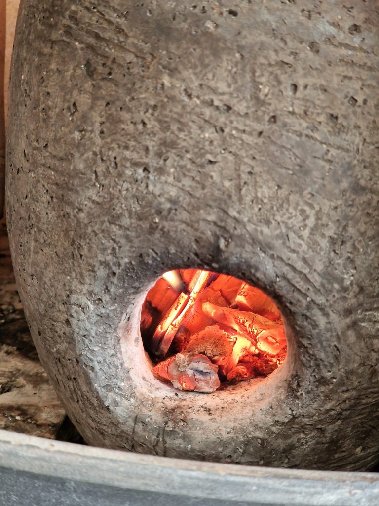 Bisque fire ceramic in an wood stove, pre heat the ceramics with a fire-pot