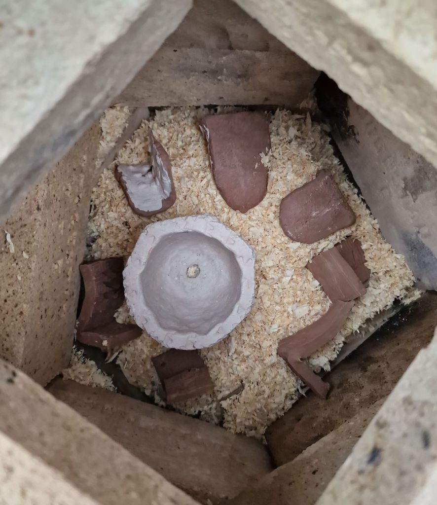 First layer of clay in the sawdust kiln