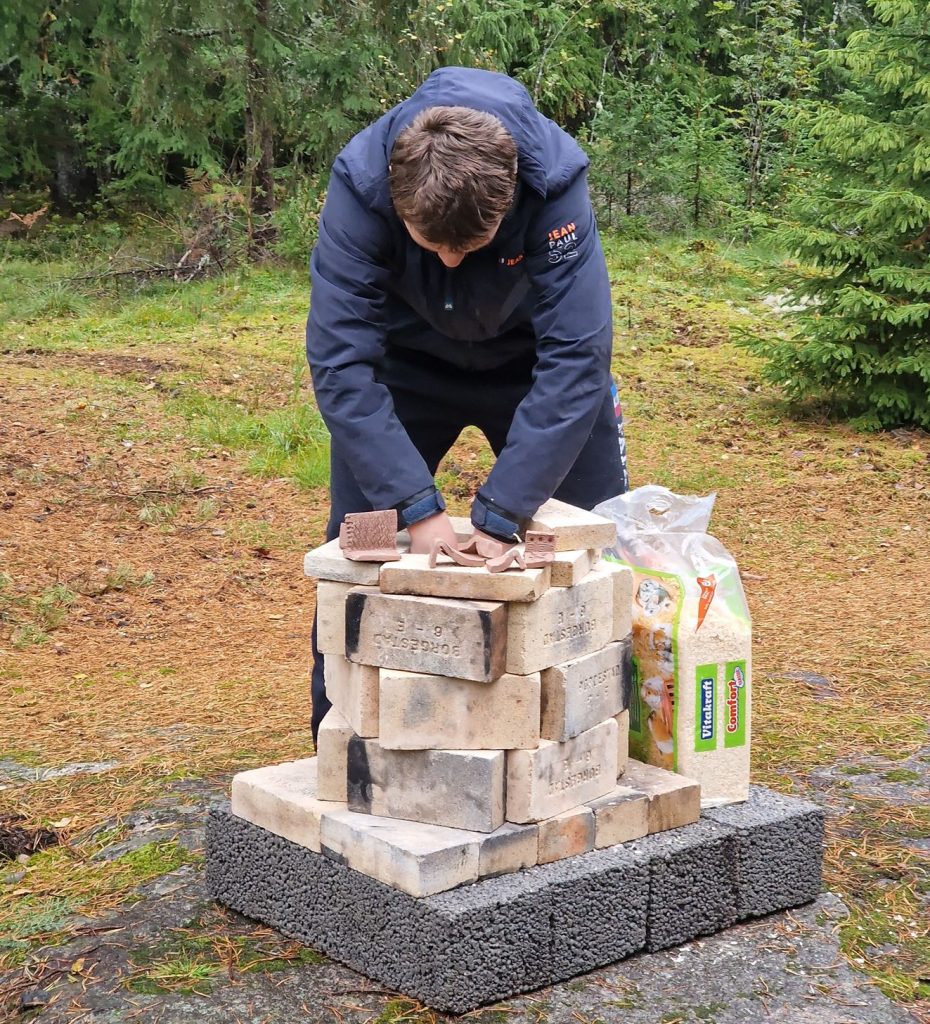 Adding sawdust to the sawdust pottery kiln